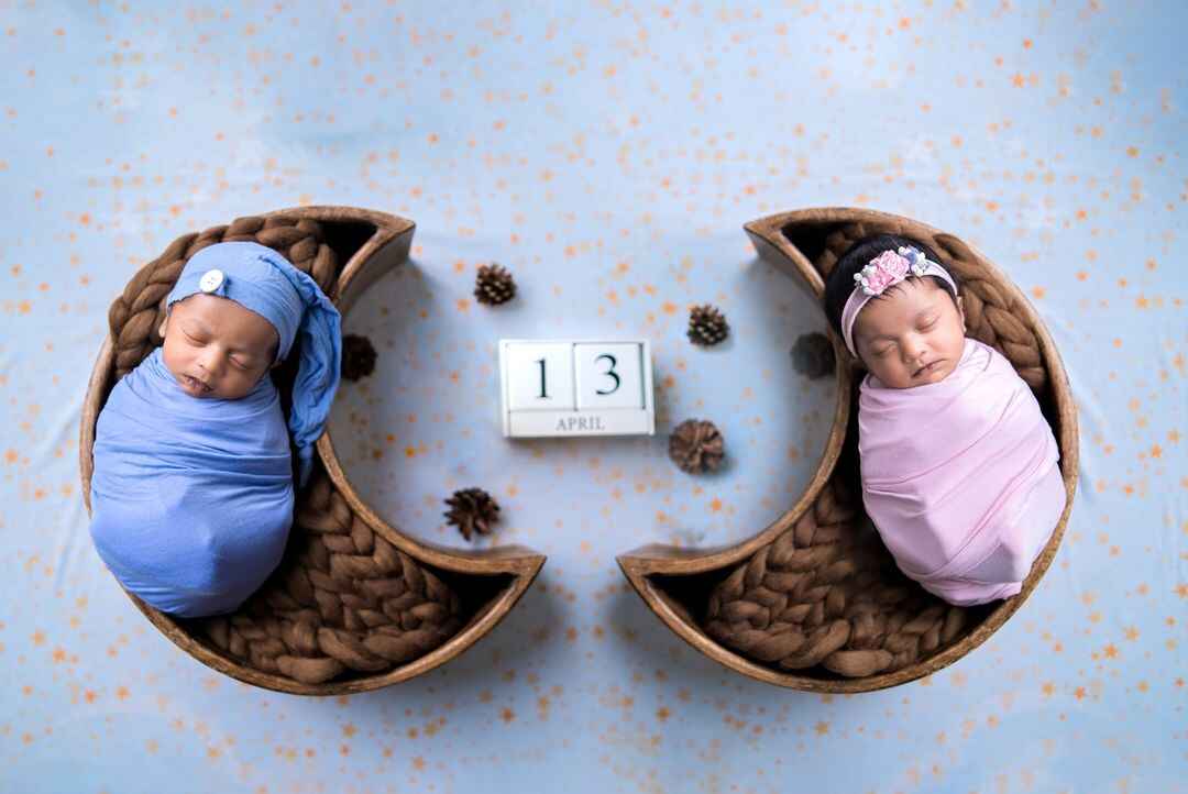 A heartwarming twin baby photoshoot with a celestial bed and milestone props.